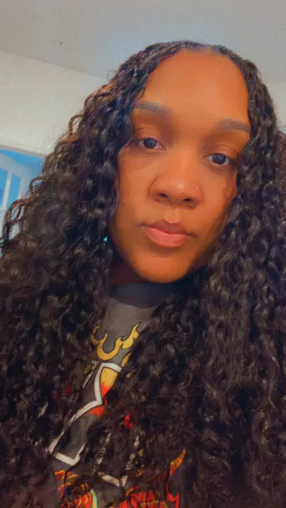 Client wearing a short curly miracle knots style — Miracle Knots